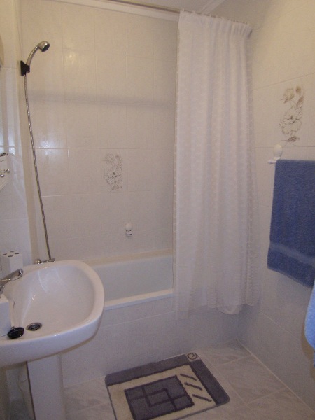 The bathroom with bath and overhead shower